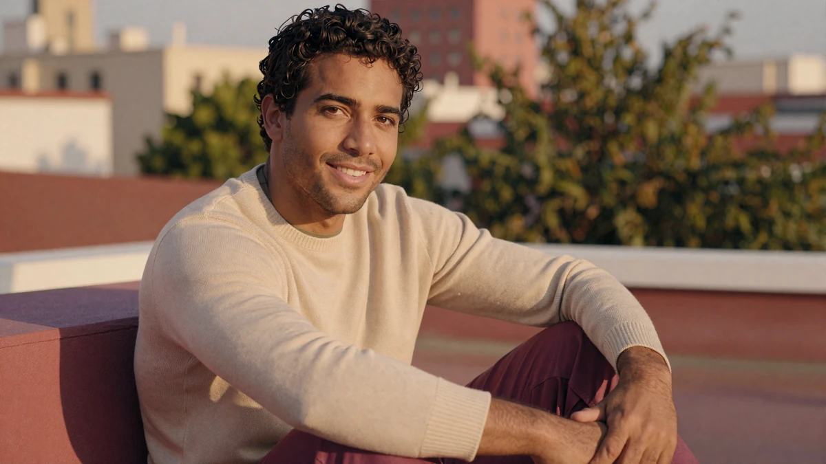 Confident man with relaxed smile illustrating building penis size confidence through self-acceptance and a sex positive community